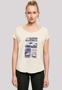 Beige short-sleeve t-shirt with a blue graphic design featuring images and text about the Austin Allegro 3. Soft texture, relaxed fit.