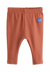 Rust-colored ribbed baby leggings with elastic waistband and a small blue label reading "smile little one" on the right hip.