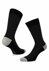 Czarne skarpetki w wzór w kropki w kolorze białym, z wzmocnionymi szarymi palcami i piętą. Wykonane z miękkiego, elastycznego materiału.