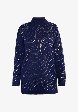 Suéter navy de cuello alto, con patrones en forma de olas hechos de lentejuelas doradas y plateadas en el frente. Tejido de punto suave y texturizado.