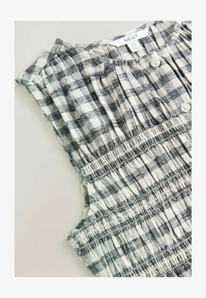 Grijze en witte geruite mouwloze top met een geplooid ontwerp, voorzien van knopen en textiel met structuur voor een ontspannen pasvorm.