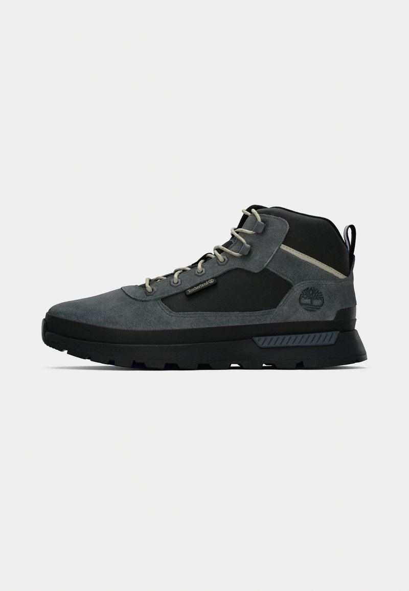 Gray hiking boots with a combination of suede and synthetic materials. Features dark accents, light laces, textured sole, and a logo detail.
