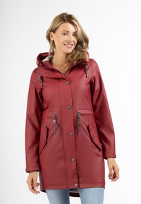 Red waterproof jacket with a hood, featuring gray drawstrings, two front pockets, and snap-button closure. Smooth texture and mid-length design.