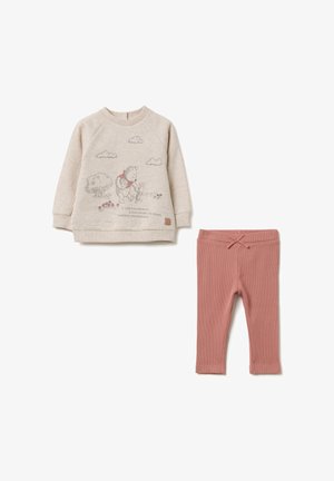 Helles beige Sweatshirt mit einem Cartoon-Design, das einen Bären und einen Tiger zeigt, kombiniert mit rosa gerippten Leggings und einem dekorativen Kordelzug.