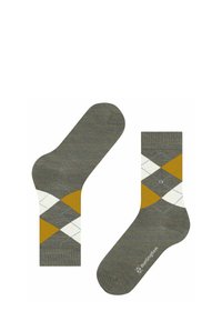 Calzini verdi con un motivo argyle giallo e bianco, mostrati in piano con un calzino sottosopra, che evidenzia un'etichetta del marchio.