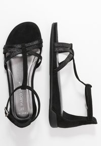 Schwarze Wildledersandalen mit glitzernden Riemen, offenes Zehendesign, gepolsterte silberne Innensohle und verstellbare Knöchellätze. Flache Sohle für Komfort.