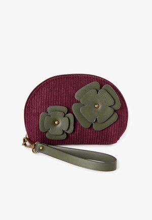 Burgundy corduroy pouch with green leather flower accents and a gold button. Features a wrist strap and a zip closure. Compact and rounded shape.