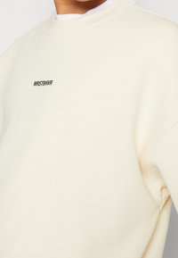 WRSTBHVR Felpa con zip - beige