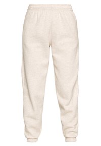 Licht beige joggingbroek van zachte stof, met een elastische tailleband en boorden, in een relaxte pasvorm en subtiele textuur.