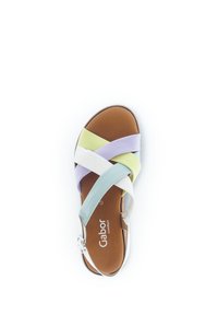 Multicolored sandal with straps in white, lavender, light green, and mint. Features a brown sole and adjustable buckle for fit.