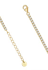 Kuldne käevõru selgete rhinestone'idega sirges joones, millel on vähikleebist, ja reguleeritav nöör ümmarguse sildiga.