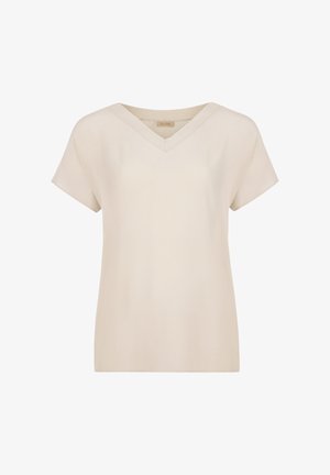 Beżowa bluzka w serek z krótkim rękawem, wykonana z gładkiego materiału, o luźnym kroju i prostych liniach, bez widocznych wzorów lub akcentów.