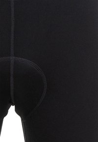 Schwarze Radhosen aus dehnbarem Stoff. Verfügen über flache Nähte, eine gepolsterte Einlage und eine eng anliegende Passform für zusätzlichen Komfort beim Radfahren.