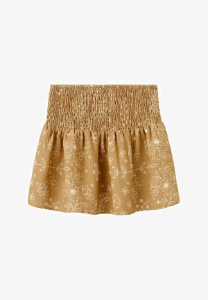 Bež krilo z nabranim pasom in belim vezenim cvetličnim vzorcem na lahkem blagu.