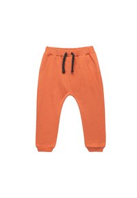 Pomarańczowe dresy wykonane z bawełny, z bocznymi kieszeniami, elastycznym pasem z czarnym sznurkiem oraz zwężanymi mankietami.