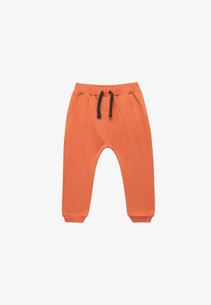 Pantalons de jogging orange en coton, avec poches latérales, taille élastique avec cordon noir, et poignets resserrés.