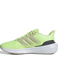 Helle grüne Sportschuhe mit Obermaterial aus Mesh, drei beigen Streifen, gepolstertem Kragen und einer weißen Zwischensohle mit strukturierten Details.