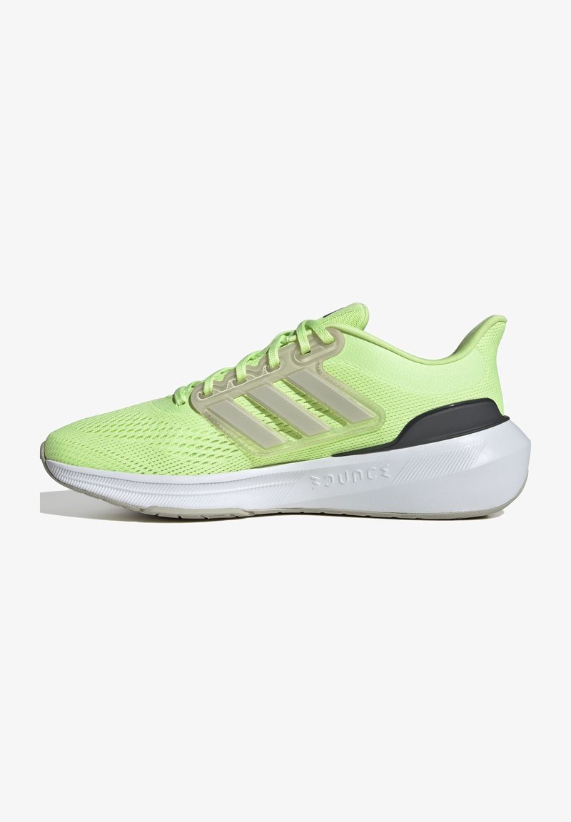 Helle grüne Sportschuhe mit Obermaterial aus Mesh, drei beigen Streifen, gepolstertem Kragen und einer weißen Zwischensohle mit strukturierten Details.