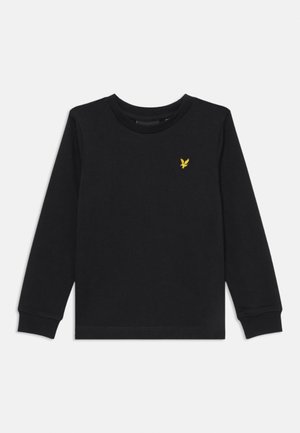 T-shirt noir à manches longues en coton, avec un col rond et des poignets côtelés. Un petit logo d'aigle jaune est brodé sur la poitrine.