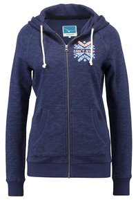 Marineblauwe zip-up hoodie met een zachte textuur, twee voorzakken en een capuchon met trekkoord. Voorzien van een multikleurige print met de tekst "CAN'T STOP" op de borst.