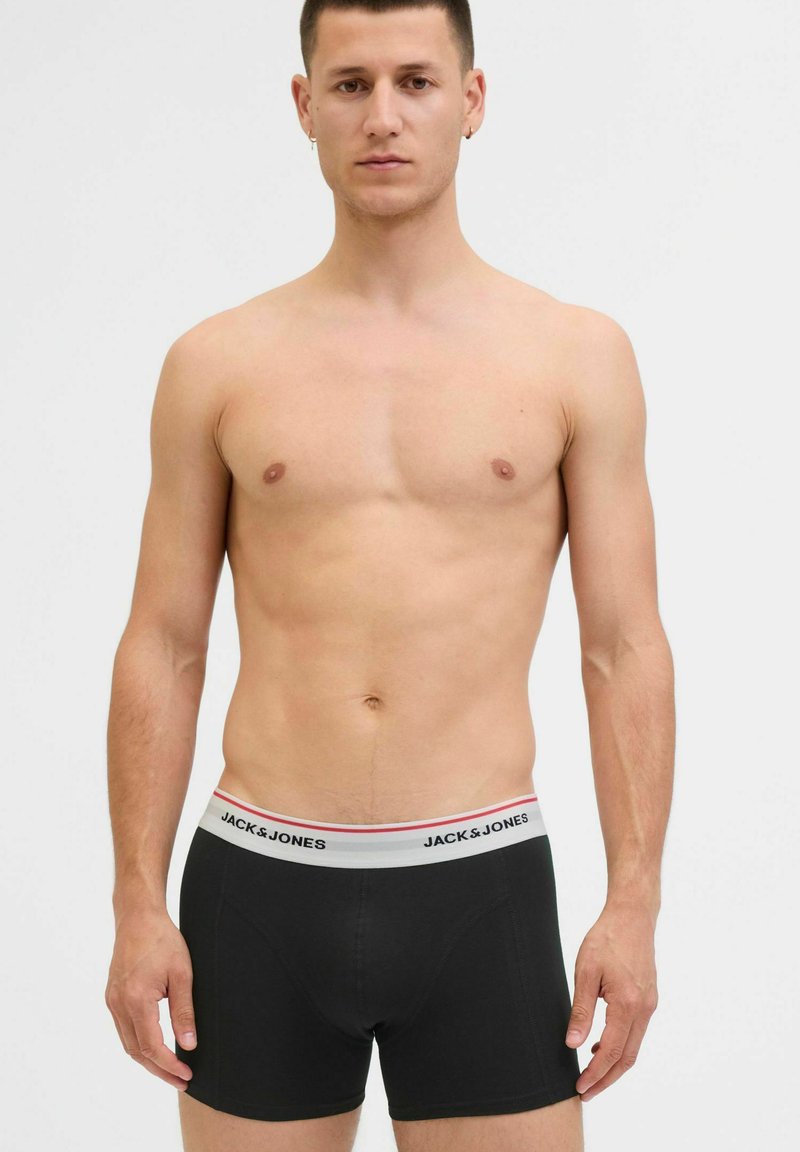 Schwarze Boxer-Shorts mit einem grauen Bund, der den Markennamen "JACK & JONES" in Schwarz zeigt. Enganliegendes Design, glatte Textur.