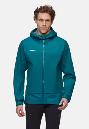 Teal waterproof jacket with a zip front, adjustable hood, textured fabric, logo on chest, and elastic cuffs for enhanced fit.