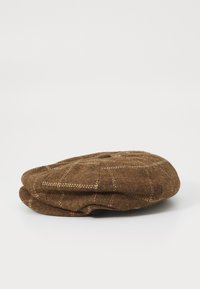 Brown wool flat cap featuring a houndstooth pattern, round crown, and stitched accents, with a soft, textured finish.