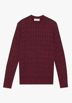 Burgundy cable-knit sweater with a crew neck, long sleeves, ribbed cuffs and hem, featuring a small blue logo on the chest.