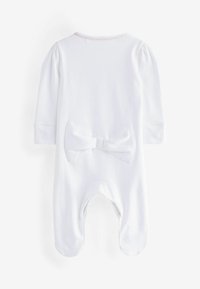 Body in cotone bianco per neonati con maniche lunghe, una texture morbida e un grande fiocco decorativo sulla parte posteriore, design con piedi per garantire calore.