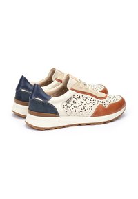 Zapatillas deportivas con parte superior de crema perforada, acentos en azul marino y marrón, cierre con cordones y suela de goma texturizada.
