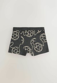 Boxers noirs pour garçons avec motif beige de ballon de football et cordon, taille élastique et coutures frontales cousues.