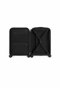 Black hard-shell suitcase with zippered compartments, strap system for contents, and four multi-directional wheels for mobility.