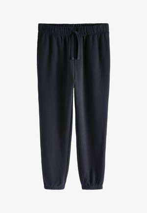 Navy blue waffle-textured jogger pants with an elastic waist and adjustable drawstring. Fitted cuffs at the ankles. Simple, casual design.