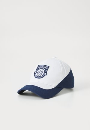 White and navy baseball cap with embroidered logo featuring a circular design and the text "FC COPENHAGEN." Cotton material, structured shape.