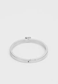 Silver bangle bracelet with a smooth finish, circular shape, and a hinge closure, featuring a simple, minimalistic design.
