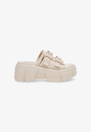 Beige platform slide sandal med tykk gummisål, med to brede stropper og metalliske detaljer. Glat tekstur og åben bagside.