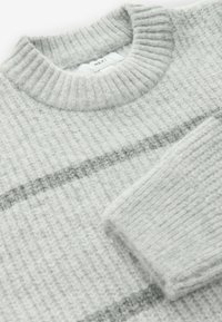 Gray knit sweater with a ribbed texture, featuring a round neckline and horizontal light gray stripes. Soft, cozy material.