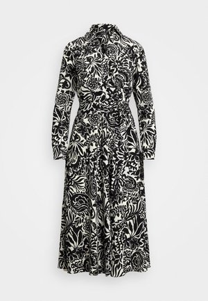 Šaty s dlouhým rukávem mají černo-bílý květinový vzor, límeček a pásek v pase pro nastavitelnou velikost.