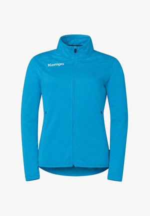 Heldere blauwe jas met volledige ritssluiting, hoge kraag, lange mouwen en "Kempa"-logo op de linkerborst, ontworpen voor outdoor- of sportkleding.