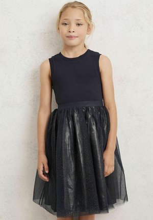 Námořnické šaty s bezramenným těsným korzetem, podšívkou z tylu, zdobené stříbrnými puntíky. Měkká textura a délka ke kolenům.