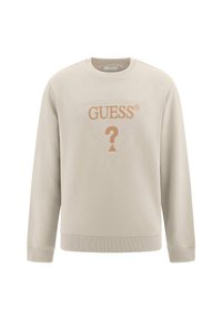 Sudadera beige hecha de un tejido suave. Presenta puños y bajo acanalados, cuello redondo y un logotipo frontal con un diseño triangular y un signo de interrogación.