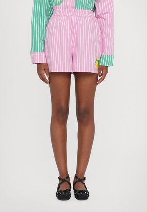 Pink and white striped shorts with an elastic waistband, featuring yellow fruit embroidery. Worn with black, polka dot ballet flats.