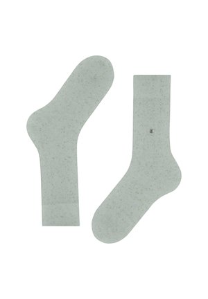 Jasnozielone skarpetki sportowe w cętki ułożone na płasko, pokazujące widok z przodu i z tyłu, z prążkowanymi mankietami i małym okrągłym logiem na jednej skarpetce.