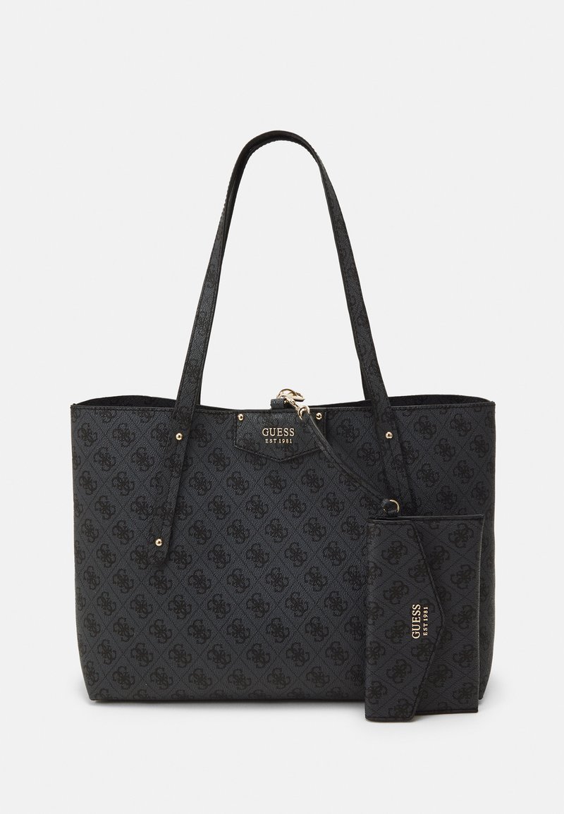 Black patterned tote bag with two handles, textured surface, gold-tone hardware, and a detachable wallet. Modern design and spacious interior.