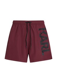 Bañador burdeos con logo negro en el lateral, cintura elástica y cordón ajustable. Hecho de material ligero, presenta una textura suave.