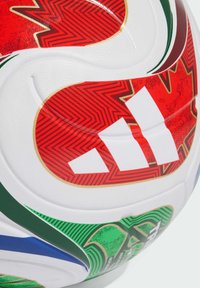 White Adidas soccer ball with red, green, and blue graphic elements and textured surface patterns.
