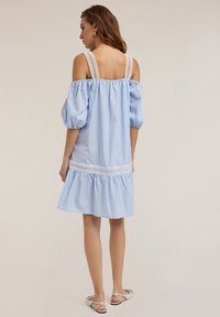 Vestido de tirantes azul claro con rayas, escote off-shoulder, mangas abullonadas, corpiño acentuado con encaje y dobladillo en capas con volantes. Ajuste casual, diseño a la altura de la rodilla.