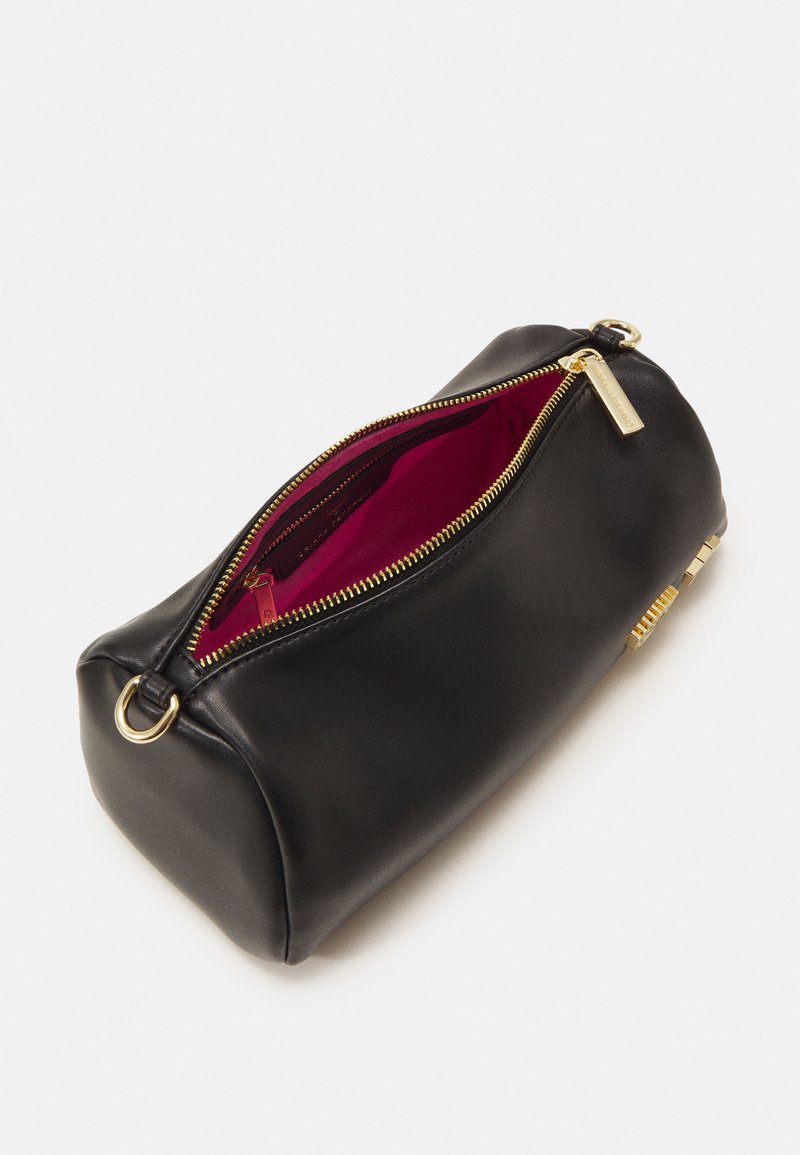 Black leather pouch with a gold zipper. Features a deep red interior lining. Oval shape with a metal accent and a loop for attaching.