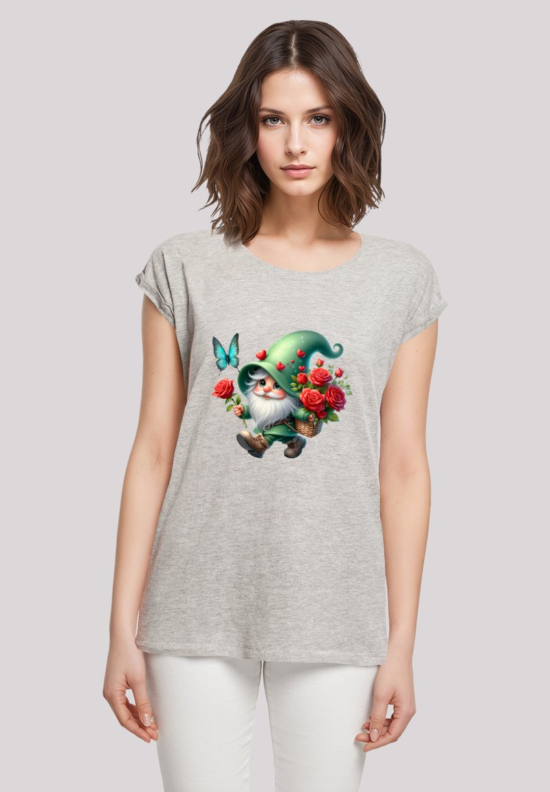Gray short-sleeve t-shirt featuring a colorful graphic of a gnome holding flowers and a butterfly against a soft background.