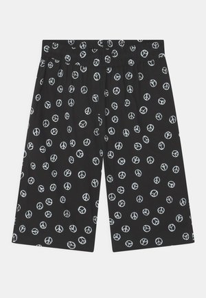 Black shorts featuring an all-over white peace sign pattern, elastic waistband, and loose fit, made from lightweight fabric.